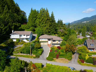 Nestled amidst lush greenery and mature trees, this stunning property offers a serene retreat with breathtaking mountain views.