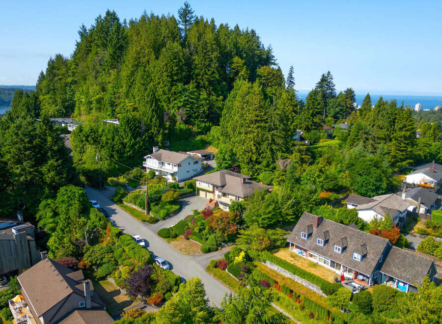 Discover this stunning hillside residence offering breathtaking panoramic views of the ocean and distant city skyline.