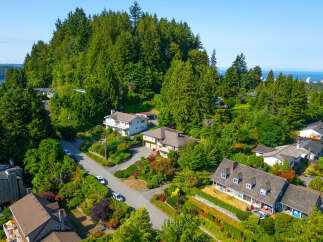 Discover this stunning hillside residence offering breathtaking panoramic views of the ocean and distant city skyline.