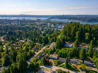Experience breathtaking panoramic views from this stunning property, nestled amidst lush greenery and mature trees.