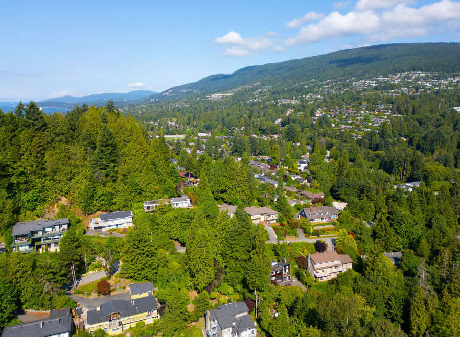 Nestled amidst lush greenery, this stunning property offers breathtaking views of the surrounding mountains and water.
