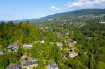 Nestled amidst lush greenery, this stunning property offers breathtaking views of the surrounding mountains and water.