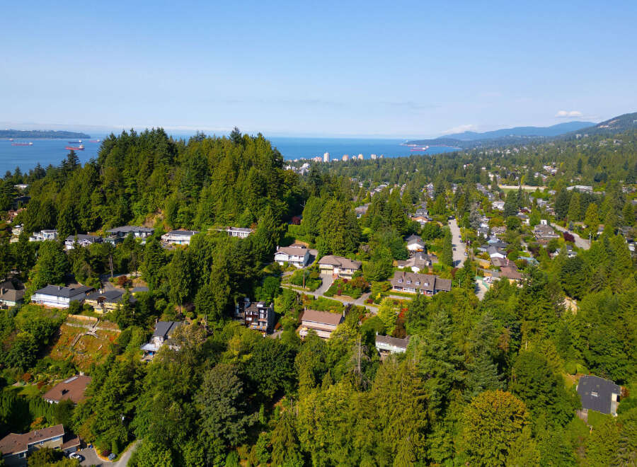 Experience breathtaking views from this stunning hillside property, nestled amidst lush greenery and mature trees.
