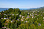 Experience breathtaking views from this stunning hillside property, nestled amidst lush greenery and mature trees.