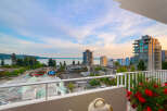 Enjoy breathtaking views from this stunning property, featuring a spacious balcony overlooking the water and city skyline.