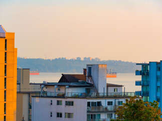 Experience stunning waterfront living with panoramic views of the ocean and distant city skyline.