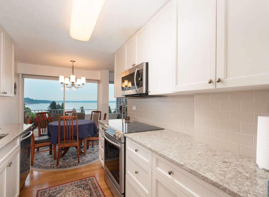 Enjoy breathtaking water views from this stunning kitchen and dining area, perfect for entertaining.
