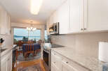 Enjoy breathtaking water views from this stunning kitchen and dining area, perfect for entertaining.