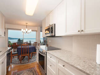 Enjoy breathtaking water views from this stunning kitchen and dining area, perfect for entertaining.