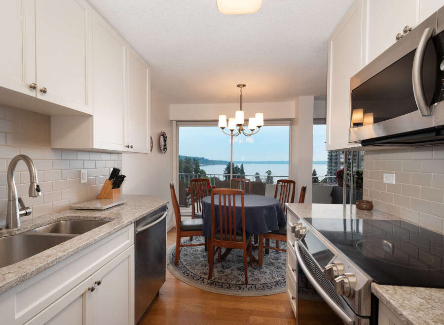 Enjoy breathtaking water views from this charming kitchen and dining area, perfect for entertaining.