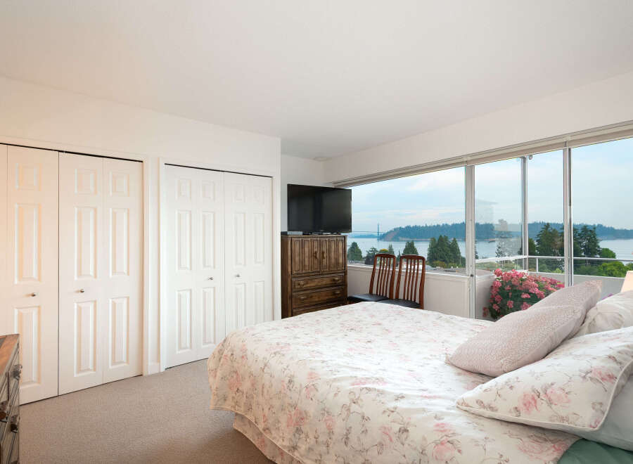 Wake up to breathtaking water and bridge views from this serene bedroom.