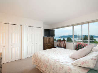 Wake up to breathtaking water and bridge views from this serene bedroom.
