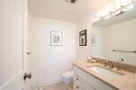 This charming bathroom features a modern vanity with a granite countertop and a sleek undermount sink, complemented by brushed nickel fixtures.