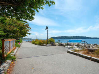 Discover this stunning waterfront property with a scenic walking path leading to breathtaking ocean views.