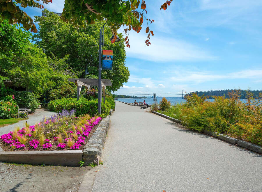 Enjoy scenic waterfront living with this stunning property featuring a paved walkway perfect for leisurely strolls along the water.