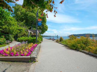 Enjoy scenic waterfront living with this stunning property featuring a paved walkway perfect for leisurely strolls along the water.