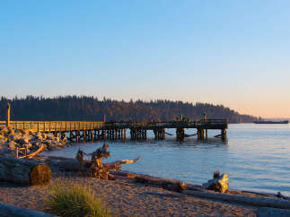 Experience serene waterfront living with this stunning property featuring a picturesque pier extending into the calm waters.