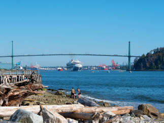 Experience waterfront living with stunning views of the Lions Gate Bridge and a bustling harbor.