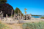 Discover a unique waterfront property featuring a charming, rustic wooden playground perfect for family fun.