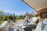 Experience breathtaking mountain views from this stunning outdoor living space, perfect for relaxation and entertaining.
