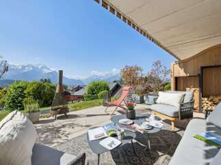 Experience breathtaking mountain views from this stunning outdoor living space, perfect for relaxation and entertaining.