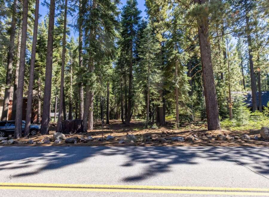 Nestled amongst towering pine trees, this property offers a serene and private setting.