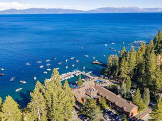 Experience the ultimate lakeside living with this stunning property offering direct access to a vibrant marina and crystal-clear waters.