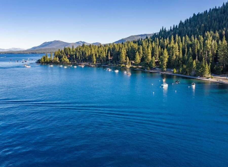 Experience the ultimate lakeside living with this stunning property offering direct access to crystal-clear blue waters.