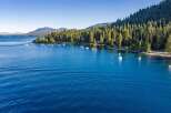 Experience the ultimate lakeside living with this stunning property offering direct access to crystal-clear blue waters.