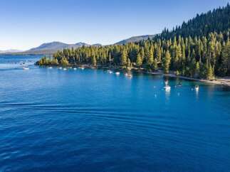 Experience the ultimate lakeside living with this stunning property offering direct access to crystal-clear blue waters.