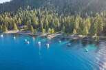 Experience the ultimate lakeside lifestyle with this stunning aerial view of a serene lakefront property.