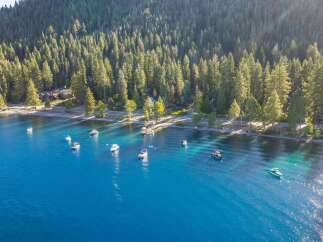 Experience the ultimate lakeside lifestyle with this stunning aerial view of a serene lakefront property.