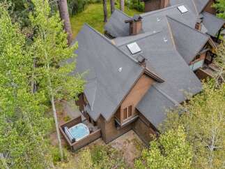 Experience ultimate relaxation in this stunning property featuring a private hot tub, perfect for unwinding amidst lush greenery.