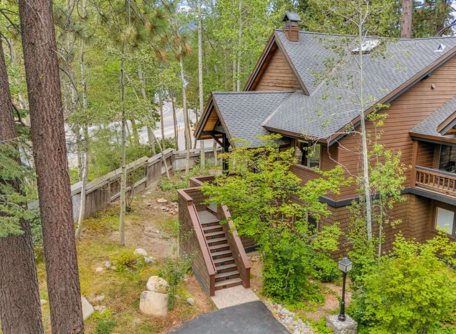 Nestled amidst lush greenery and mature trees, this charming home offers a serene mountain retreat.