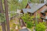 Nestled amidst lush greenery and mature trees, this charming home offers a serene mountain retreat.