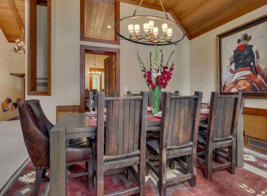 Experience rustic elegance in this spacious dining room, featuring a grand wooden table and chairs perfect for hosting.