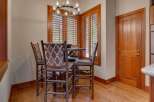 This cozy dining nook features a round table with four rustic bar stools, each adorned with a Southwestern-inspired patterned fabric.