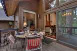 Enjoy outdoor dining on this charming deck, complete with a round table set for four and comfortable seating.
