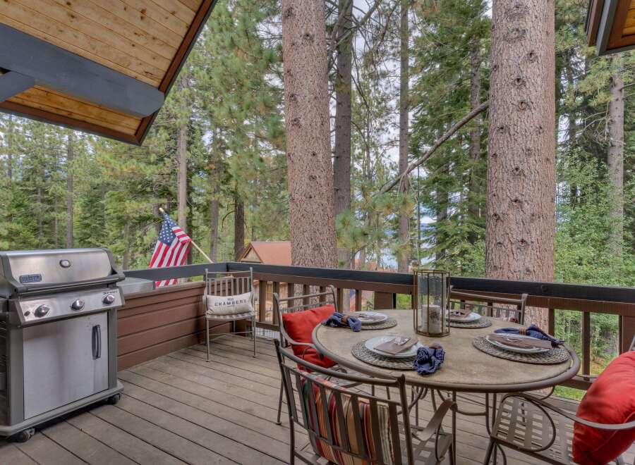 Enjoy outdoor living on this charming deck, complete with a gas grill for summer barbecues and a dining set perfect for al fresco meals.