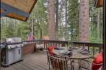 Enjoy outdoor living on this charming deck, complete with a gas grill for summer barbecues and a dining set perfect for al fresco meals.