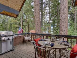 Enjoy outdoor living on this charming deck, complete with a gas grill for summer barbecues and a dining set perfect for al fresco meals.