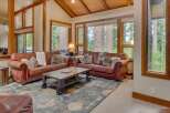 Experience rustic charm in this inviting living room, featuring plush leather sofas and a striking wooden coffee table.