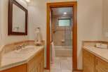 This bathroom features a spacious vanity with a double sink and ample counter space, perfect for busy mornings.