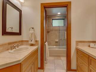 This bathroom features a spacious vanity with a double sink and ample counter space, perfect for busy mornings.