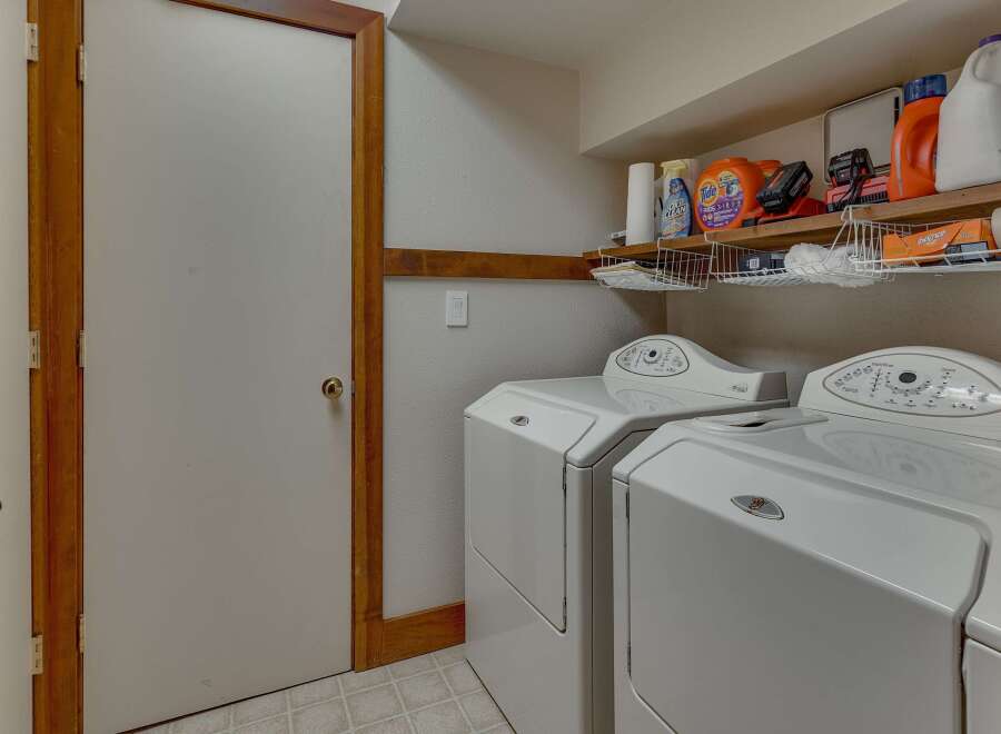 This laundry room features a convenient side-by-side washer and dryer set, perfect for handling large loads.
