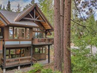 Nestled amongst towering trees, this stunning mountain home offers a perfect blend of rustic charm and modern luxury.