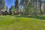Nestled amidst towering pine trees, this stunning property offers a serene retreat with its multi-level architecture and expansive green lawns.