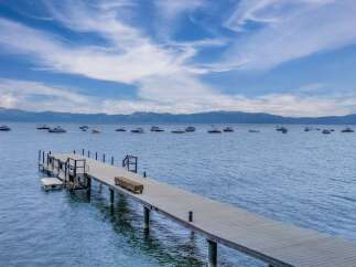 Enjoy breathtaking lake views from this stunning property featuring a private dock perfect for your watercraft.