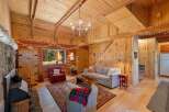 Step into a cozy cabin retreat featuring a warm, wood-paneled living area with a charming fireplace and rustic decor.