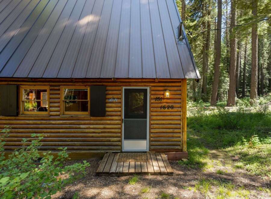 Escape to this charming log cabin nestled in a serene forest setting.